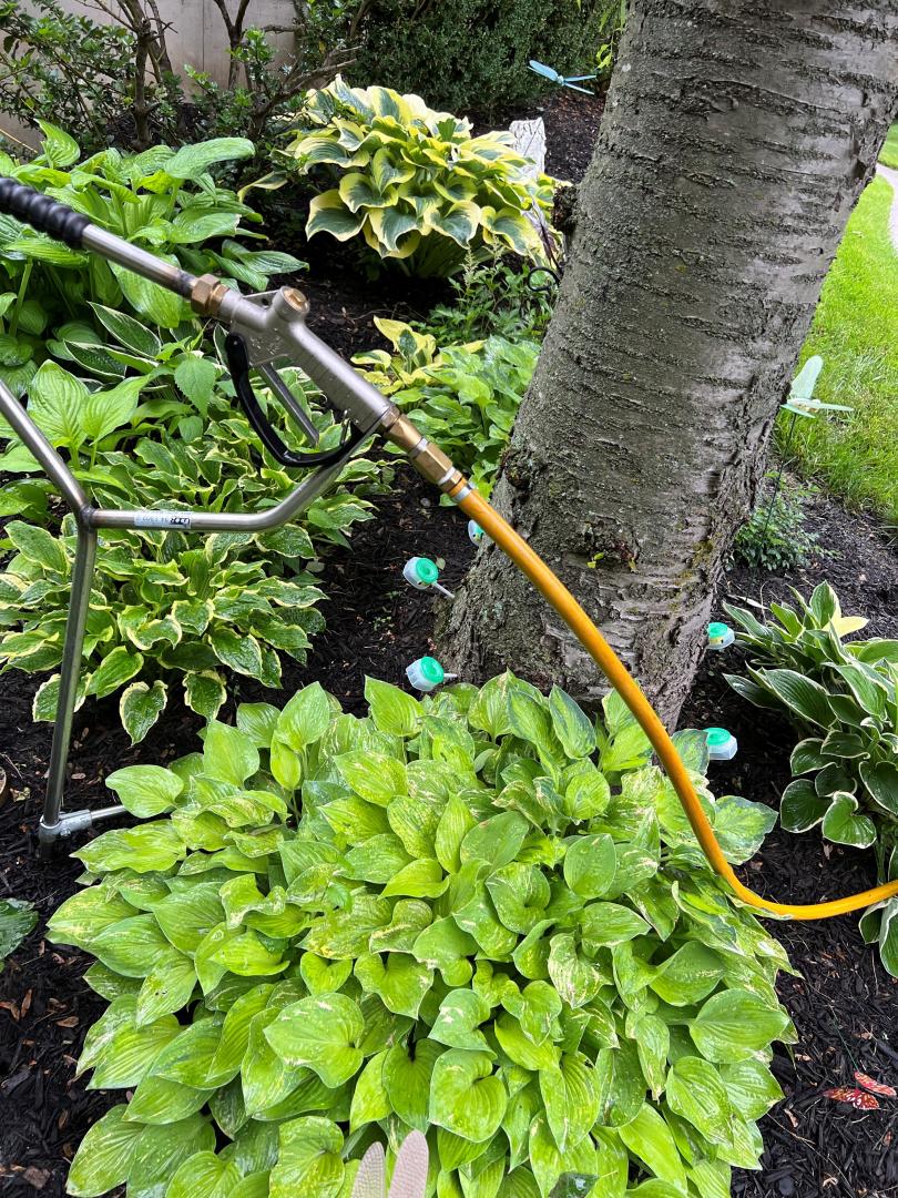 The tool shown allows liquid nutrients to be delivered below the soil directly into the root zone of trees. A pressurized pump system pushes the liquid which spreads the nutrients through the soil. 